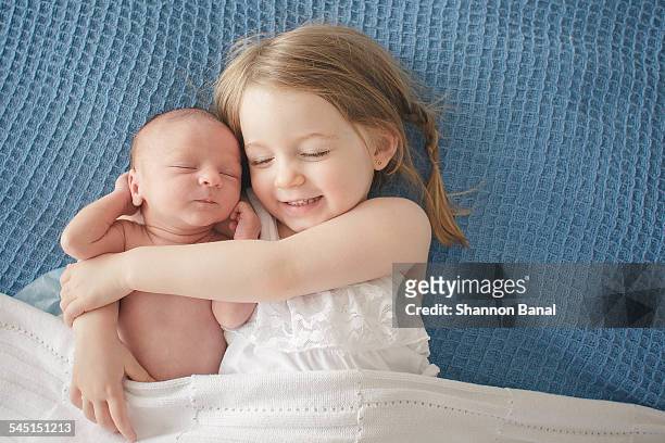 Preschool Girl Hugs Newborn Baby Brother