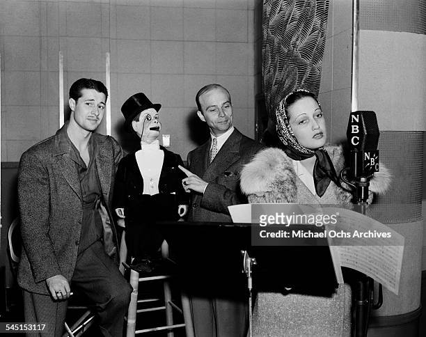 Actor Don Ameche, Charlie McCarthy, ventriloquist Edgar Bergen and actress Dorothy Lamour on set during a Radio Show in Los Angeles,CA.