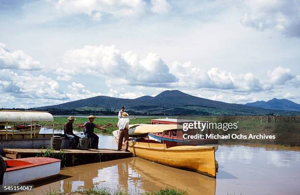 Group of fishermen stand by a boat on the lake in Patzcuaro, Michoacan, Mexico.