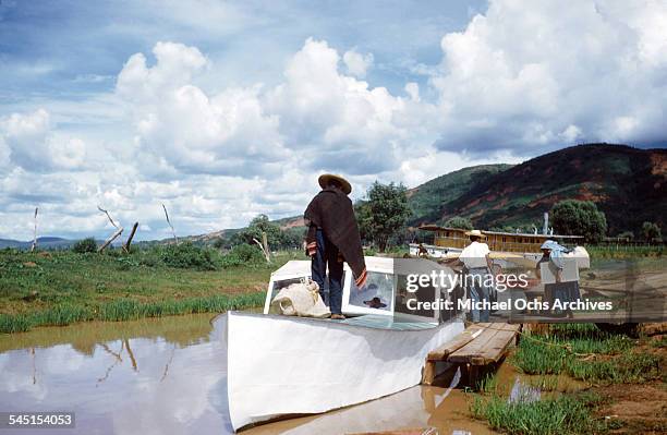 Group of fishermen get a boat ready for the lake in Patzcuaro, Michoacan, Mexico.