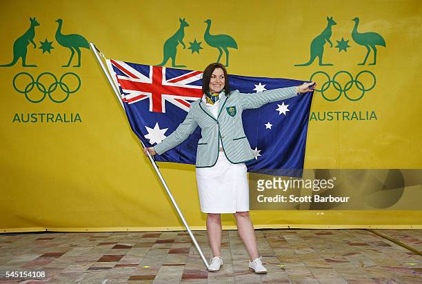 Anna Meares poses with the Australian flag during the Australian Olympic Games flag bearer announcement at Federation Square on July 6, 2016 in...
