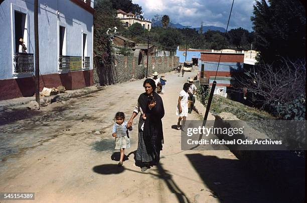 Street view of a women and young girl walking in Taxco de Alarcon, Guerrero, Mexico.