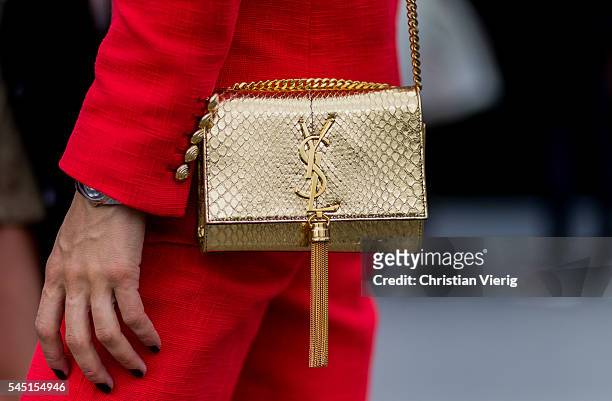 Golden Yves Saint Laurent bag outside Chanel during Paris Fashion Week Haute Couture F/W 2016/2017 on July 5, 2016 in Paris, France.