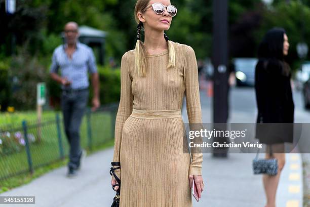 Guest wearing a beige overall outside Chanel during Paris Fashion Week Haute Couture F/W 2016/2017 on July 5, 2016 in Paris, France.