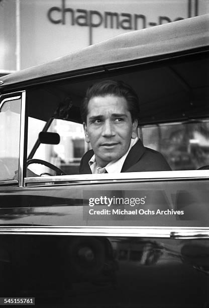 Actor Richard Conte looks on in his car in Los Angeles, California.