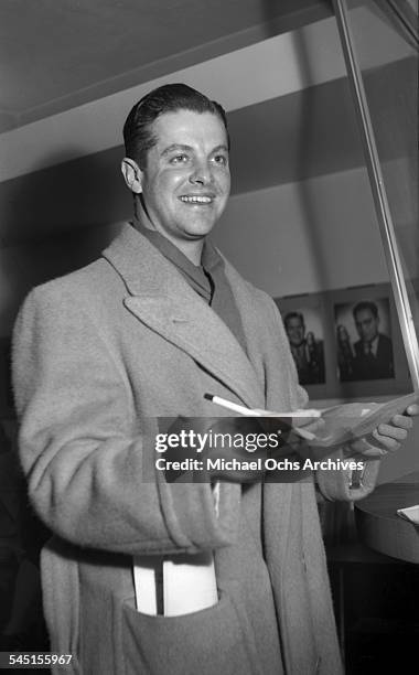 Actor Robert Cummings signs autographs for fans in Los Angeles, California.