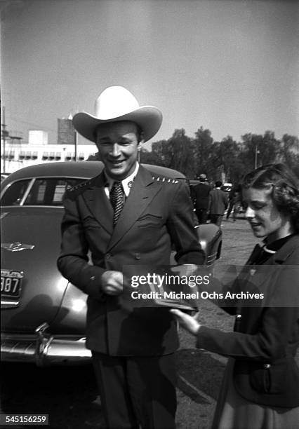 Singing cowboy Roy Rogers is greeted by a fan in Los Angeles, California.