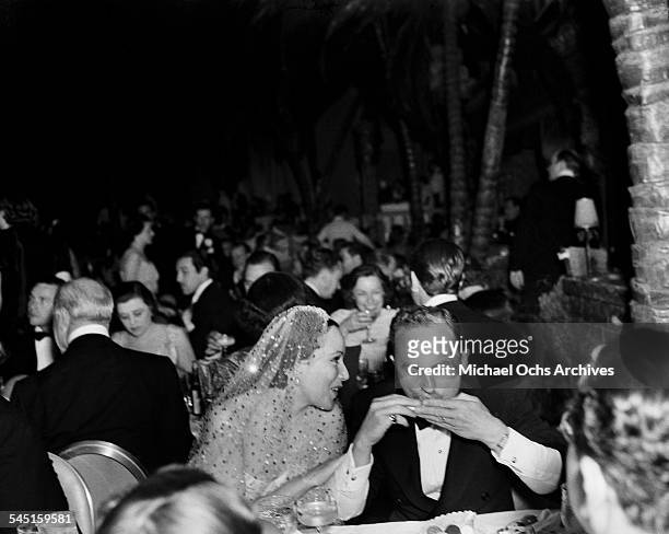 Actress Dolores del Rio talks to producer Darryl F. Zanuck during an event at the Cocoanut Grove nightclub in Los Angeles, California.