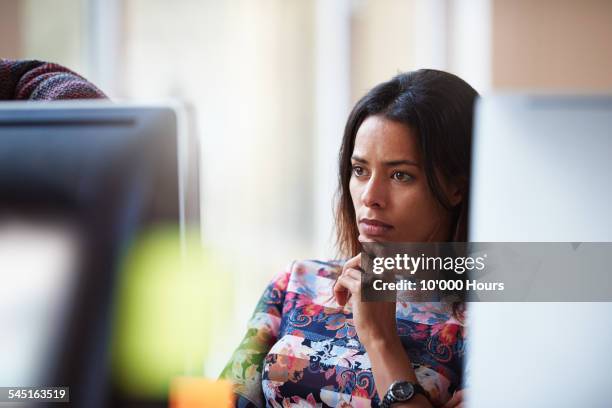 businesswoman at workstation contemplating project - brown eyes reflection stock pictures, royalty-free photos & images