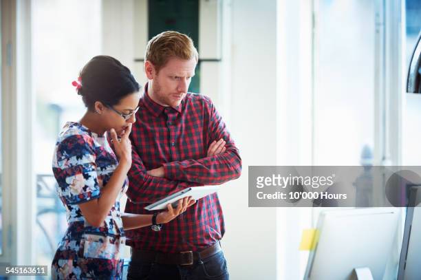 business colleagues discussing a project - two people standing stock pictures, royalty-free photos & images
