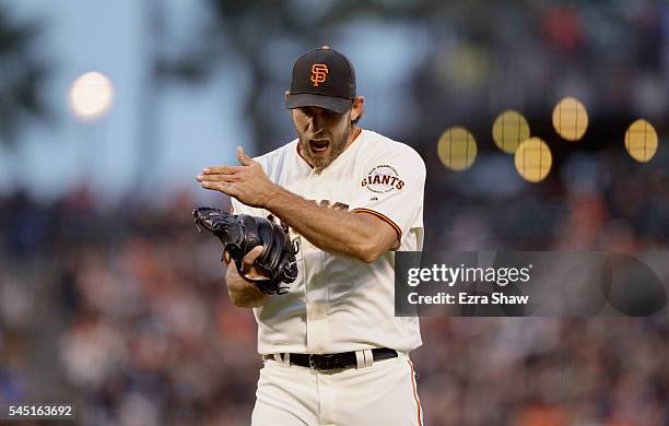 Madison Bumgarner of the San Francisco Giants reacts after Mac Williamson of the San Francisco Giants caught a fly ball hit by Trevor Story of the...