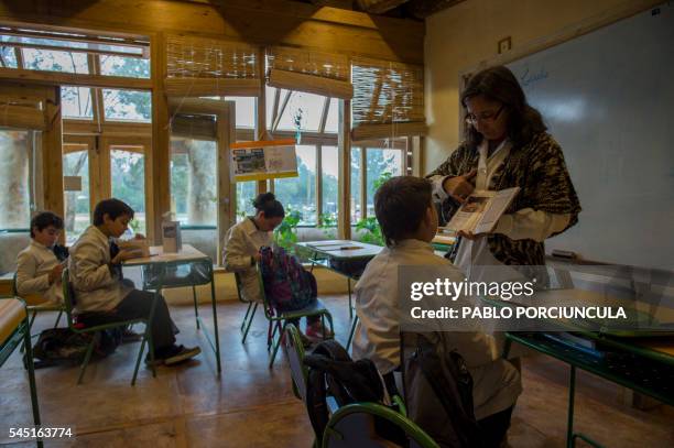 Schoolchildren take part in a class at the auto-sustainable elementary school in Jaureguiberry -80km east of Montevideo- Uruguay on June 17, 2016....