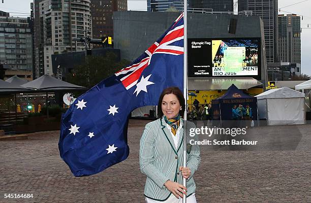 Anna Meares poses with the Australian flag during the Australian Olympic Games flag bearer announcement at Federation Square on July 6, 2016 in...