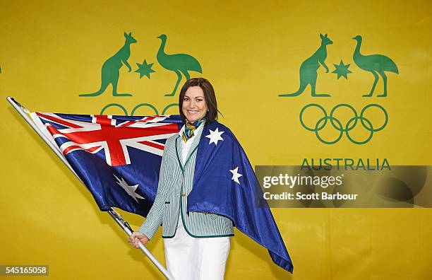 Anna Meares poses with the Australian flag during the Australian Olympic Games flag bearer announcement at Federation Square on July 6, 2016 in...