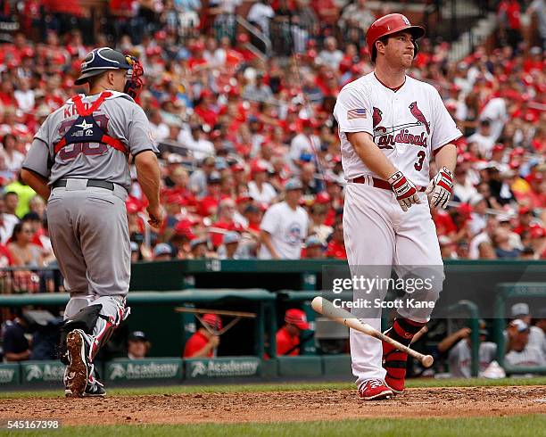 Erik Kratz of the Pittsburgh Pirates walks to the dugout as Jedd Gyorko of the St. Louis Cardinals tosses his bat after striking out to end the in...