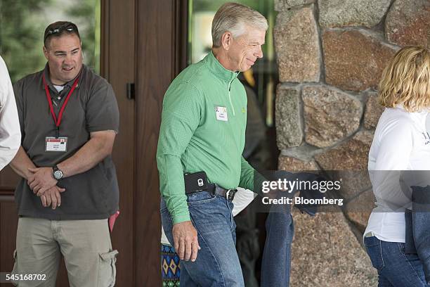 Lowell McAdam, chairman and chief executive officer of Verizon Communications Inc., center, arrives for the Allen & Co. Media and Technology...