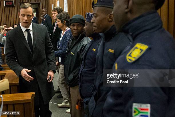 Paralympian athlete Oscar Pistorius, accused of the murder of his girlfriend Reeva Steenkamp three years ago, arrives for a hearing in his murder...