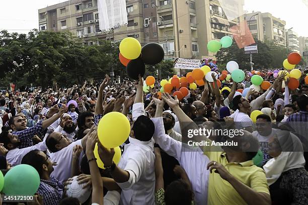 Baloons are presented for children after Muslims perform Eid al-Fitr prayer during the Eid al-Fitr holiday at Abu Bakr al-Siddiq Mosque, in Cairo,...