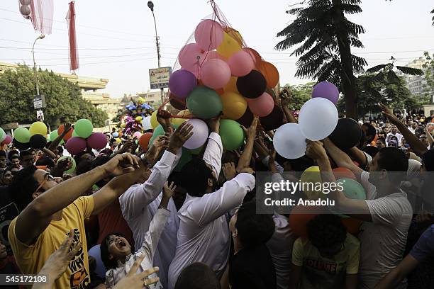 Baloons are presented for children after Muslims perform Eid al-Fitr prayer during the Eid al-Fitr holiday at Abu Bakr al-Siddiq Mosque, in Cairo,...