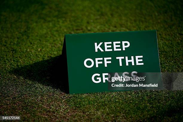 Keep Off The Grass Sign sits on Centre Court ahead of the start of play on day nine of the Wimbledon Lawn Tennis Championships at the All England...