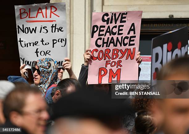 Demonstrators hold placards as they protest outside QEII Centre in London on July 6 as they wait to hear the outcome of the Iraq Inquiry. The...