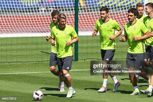 Bastian Schweinsteiger of Germany runs with the team during a Germany training session ahead of their UEFA Euro 2016 Semi final against France at...