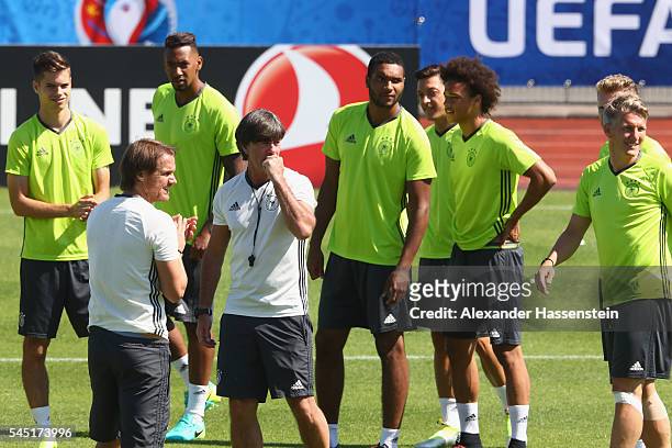 Joachim Loew, head coach of Germany talks to his players prior to a Germany training session ahead of their UEFA Euro 2016 Semi final against France...