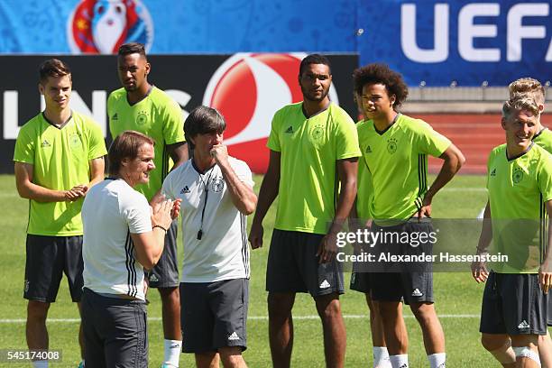 Joachim Loew, head coach of Germany talks to his players prior to a Germany training session ahead of their UEFA Euro 2016 Semi final against France...