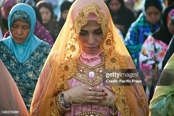 Muslim princess from Maguindanao province joins the morning prayer at the Quirino Grandstand. Filipino Muslims from nearby cities converged at the...