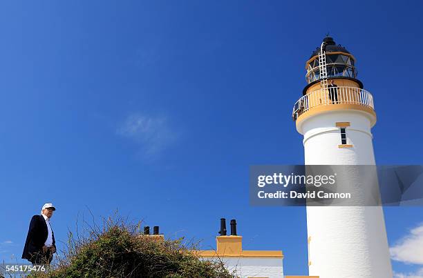 Donald Trump of the United States surveys the landscape beside the lighthouse during the re-opening of the Ailsa Course at the Trump Turnberry Resort...