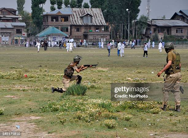 An Indian policeman Aims a pellet gun towards kashmiri Muslim protesters chanting Pro-freedom slogns during clashes after prayers marking the...