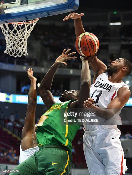 Canadian Tristan Thompson blocks a lay-up by Cheik Mbodj of Senegal during their 2016 FIBA Olympic men's qualifying basketball tournament in Manila...