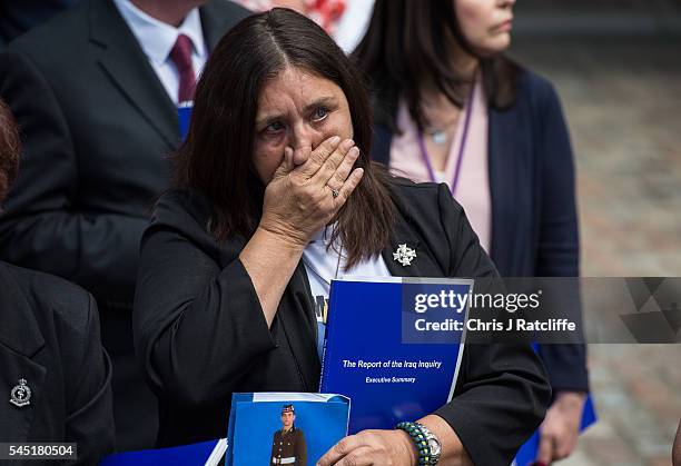 Family member of a soldier killed in the Iraq conflict reacts outside the Queen Elizabeth II conference centre after the outcome of the Chilcot...