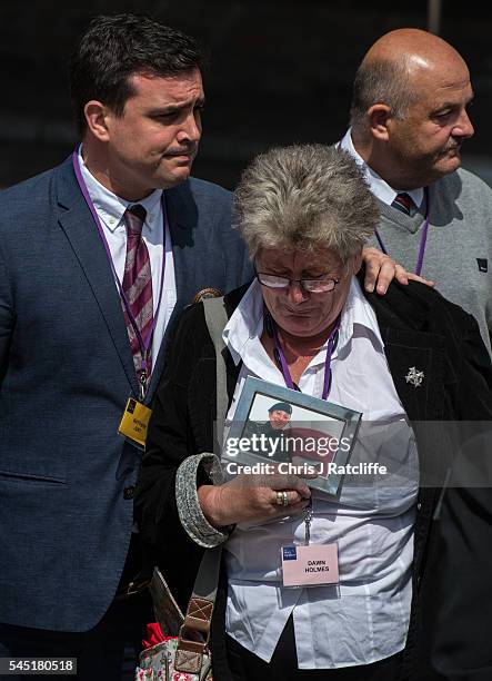 Dawn Holmes holds a picture of a relative killed in the Iraq conflict outside the Queen Elizabeth II conference centre after the outcome of the...