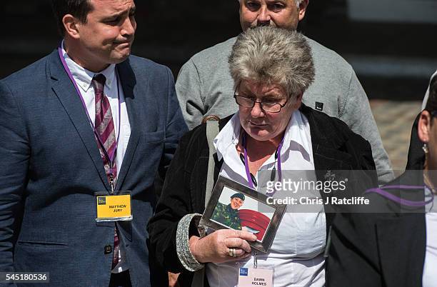 Dawn Holmes holds a picture of a relative killed in the Iraq conflict outside the Queen Elizabeth II conference centre after the outcome of the...