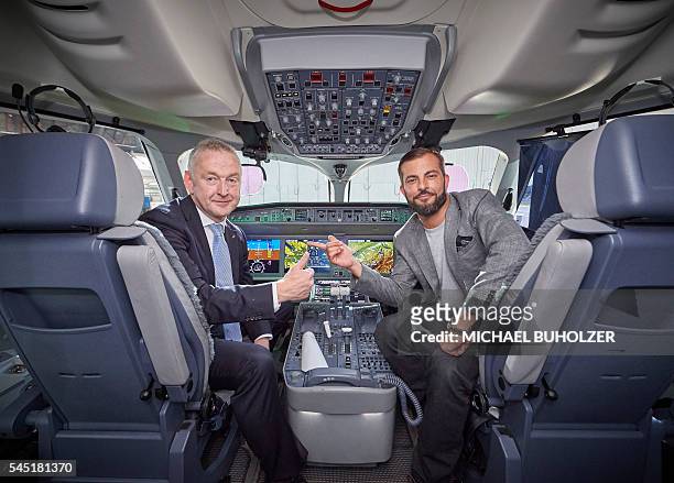 Swiss International Airlines Chief Executive Officer Thomas Kluehr and Swiss musician and godfather of the airfcraft naming celebration Bligg pose...