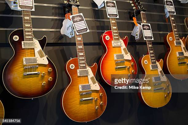 Vintage custom Gibson Les Paul guitars in various colours at a guitar shop in London, United Kingdom.
