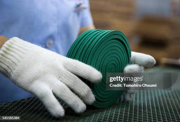 An employee sorts mosquito coils at the Kishu Factory of Dainihon Jochugiku Co. Ltd. On July 6, 2016 in Arita, Japan. Japanese insect repellent...