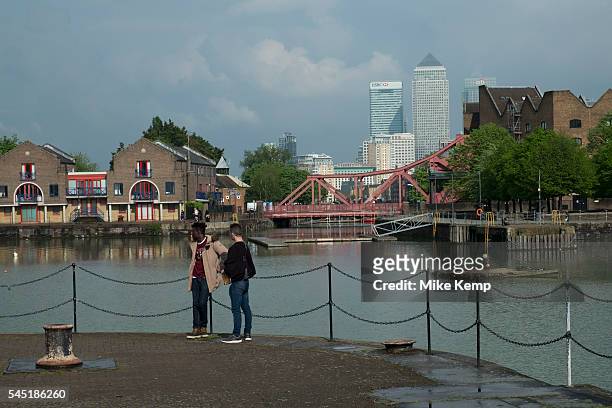 View of the Docklands area, Canary Wharf and financial district through across Shadwell Basin and via the Brunel bridge in Wapping, London, England,...