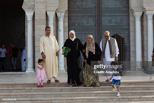 Muslims walk to perform Eid al-Fitr prayer during the Eid al-Fitr holiday at Maliq Ibn Anas Mosque in Carthage, Tunis, Tunisia on July 06, 2016. Eid...