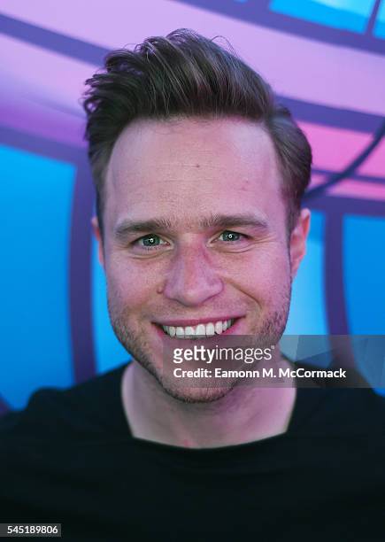 Olly Murs poses for pictures during a visit to Kiss FM on July 6, 2016 in London, England.