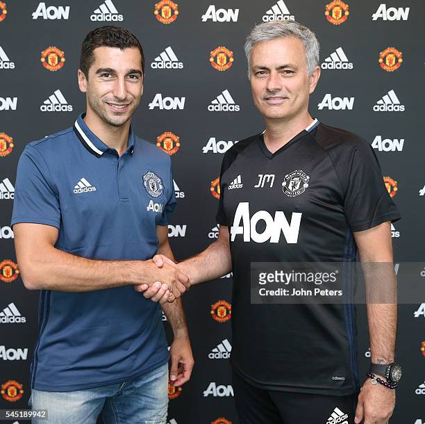 Henrikh Mkhitaryan of Manchester United poses with Manager Jose Mourinho after signing for the club at Aon Training Complex on July 6, 2016 in...