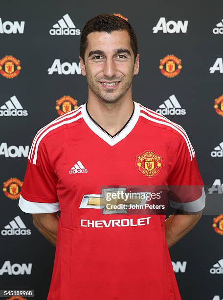 Henrikh Mkhitaryan of Manchester United poses after signing for the club at Aon Training Complex on July 6, 2016 in Manchester, England.