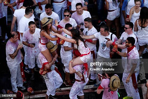 Revellers celebrate on the City Hall Square after the firing of the 'Chupinazo' which marked the official beginning of the Fiestas de San Fermin in...