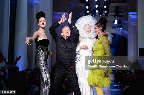 Jean-Paul Gaultier arrives at the end of the show with models Ana Cleveland , Soo Joo Park and Coco Rocha during the Jean-Paul Gaultier Haute Couture...