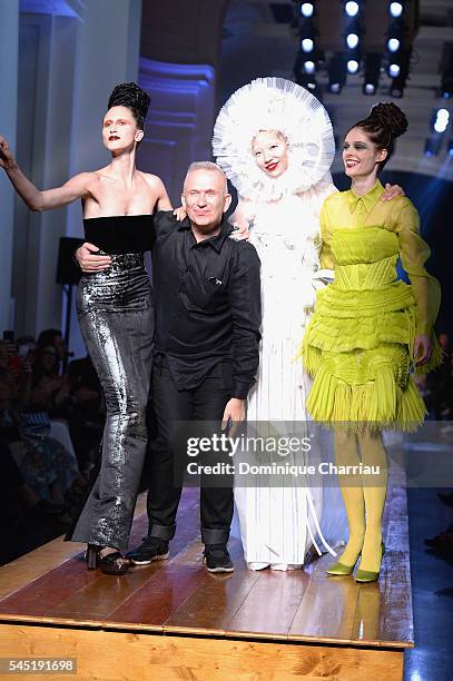 Jean-Paul Gaultier arrives at the end of the show with models Ana Cleveland , Soo Joo Park and Coco Rocha during the Jean-Paul Gaultier Haute Couture...