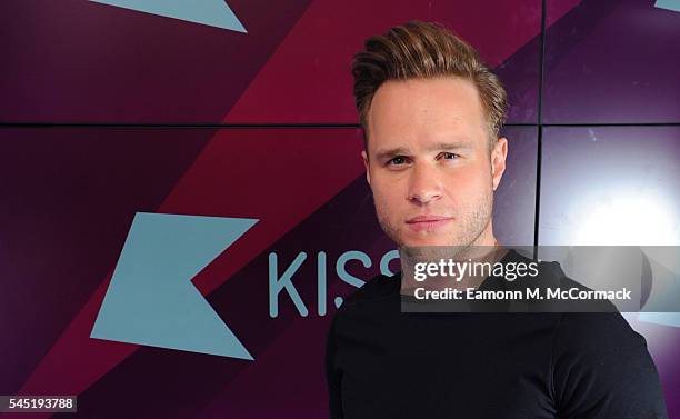 Olly Murs poses for pictures during a visit to Kiss FM on July 6, 2016 in London, England.