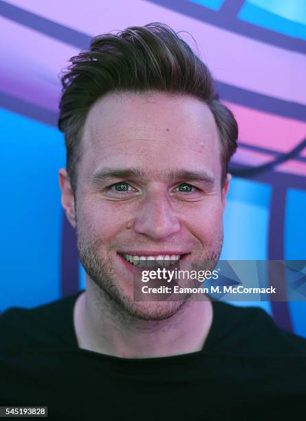 Olly Murs poses for pictures during a visit to Kiss FM on July 6, 2016 in London, England.
