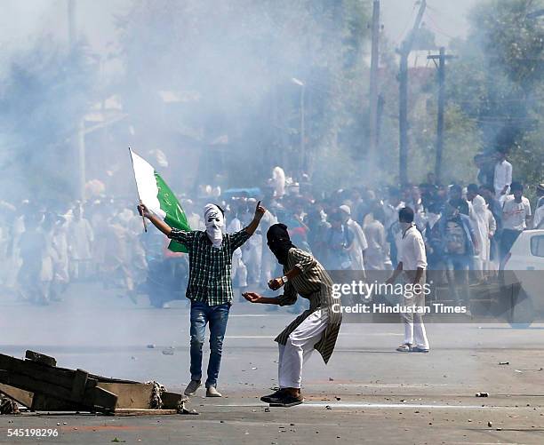 Kashmiri protesters pelting stones at the police and paramilitary soldiers during clashes after the culmination of Eid-ul-Fitr congregational...