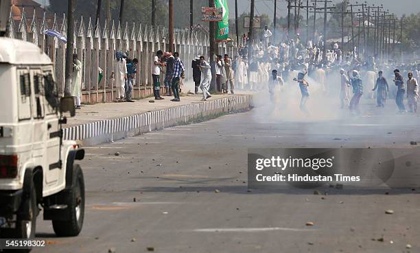 Kashmiri protesters pelting stones at the police and paramilitary soldiers during clashes after the culmination of Eid-ul-Fitr congregational...